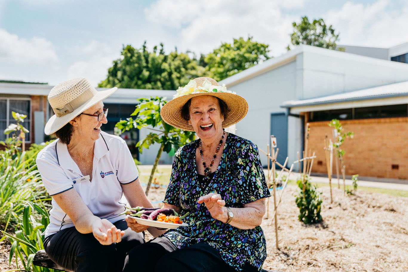 a st vincent's staff member with an aged care resident in a garden